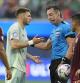 Referee Raphael Claus from Brazil listens to Mexico's Santiago Gimenez during a Copa America Group B soccer match Wednesday, June 26, 2024, in Inglewood, Calif. (AP Photo/Ryan Sun)
