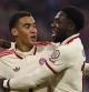 Munich (Germany), 16/09/2024.- Jamal Musiala (L) and Alphonso Davies of Bayern interact during the UEFA Champions League match between Bayern Munich and Dinamo Zagreb in Munich, Germany, 17 September 2024. (Liga de Campeones, Alemania) EFE/EPA/ANNA SZILAGYI